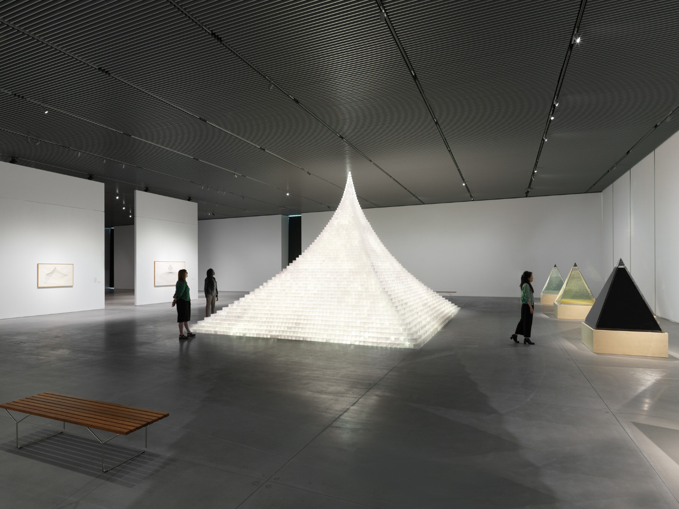 A glowing pyramid in a massive arts space, now closed due to coronavirus