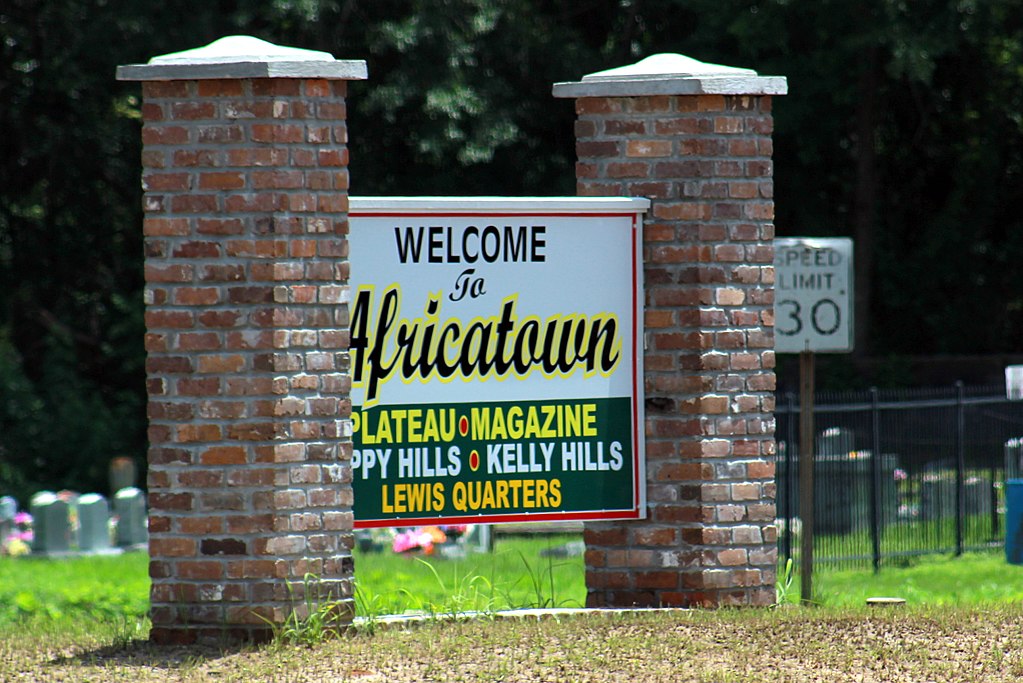 a sign welcoming visitors to Africatown