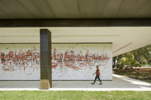 一个人走在SMUD总部的一幅巨大的彩色壁画前