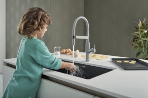 A woman washing her hands in a sink