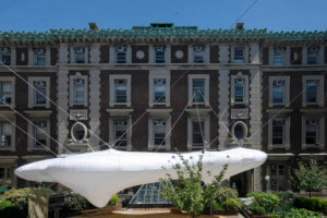 一个inflatable pavilion anchored between three neoclassical red brick buildings