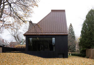 由atelier barda设计的住宅外观，黑色的立面和倾斜的屋顶突然切断