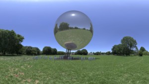 球体的渲染图，一个金属球，漂浮在田野里