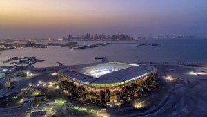 为2022年国际足联世界杯部分用集装箱堆砌而成的足球场夜间鸟瞰图