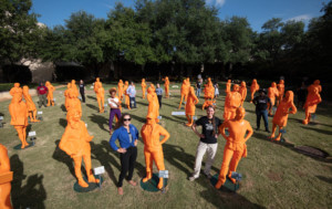 women stand in a grassy area next to their 3d-printed likenesses at the smithsonian