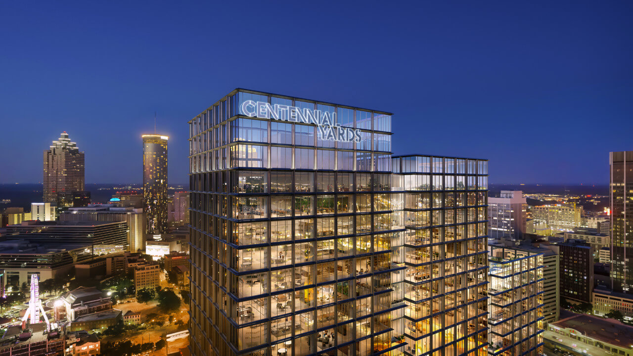 这幅效果图显示了一座由玻璃和钢铁组成的办公大楼在夜间的顶部